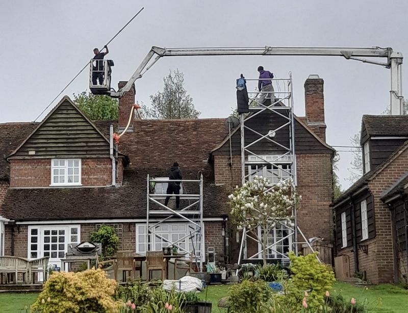 The Roof Moss Cleaners using cherry picker and scaffolding to clean roof safely and professionally in Chippenham, Wiltshire